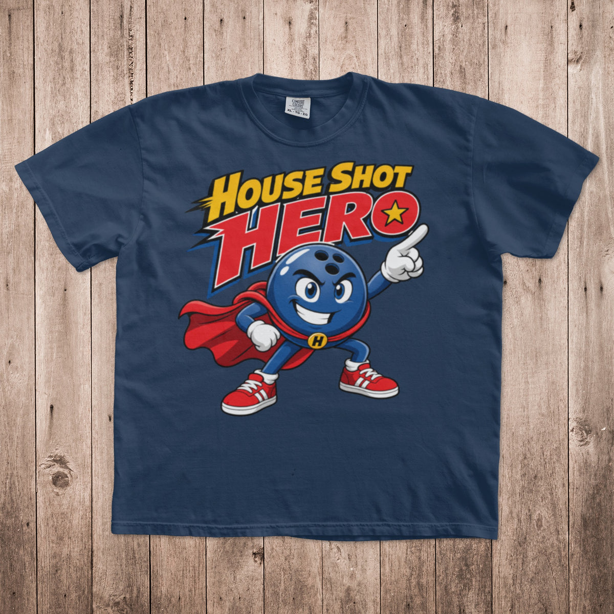 A dark blue t-shirt with a graphic of a cartoon bowling ball superhero and text reading House Shot Hero.