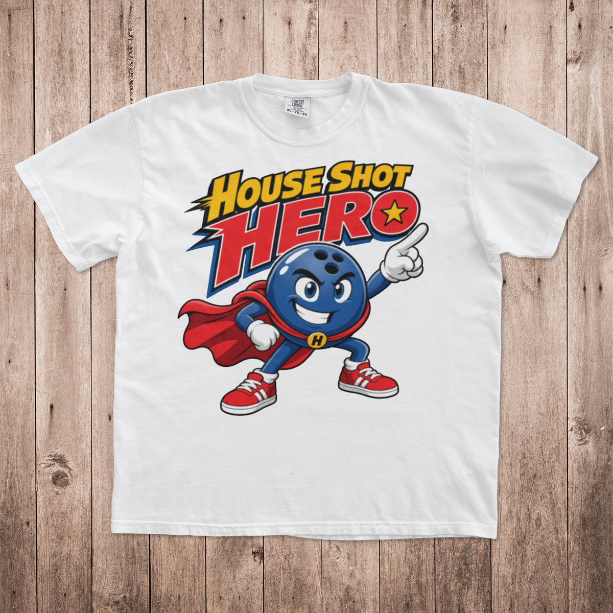 White t-shirt featuring a cartoon bowling ball superhero graphic with the text House Shot Hero.